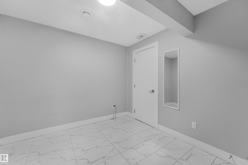 White tile flooring with dark veining - 3359 13 Avenue Nw, Edmonton, AB 