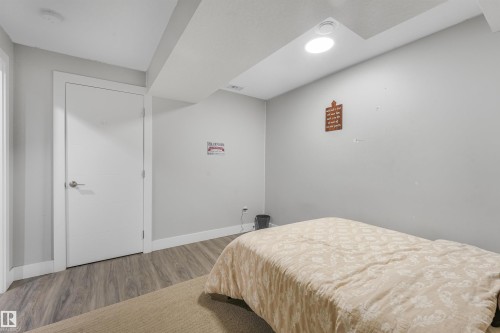 Recessed lighting, wood-finish flooring, white interior door, light gray wall color, and white trim - 3359 13 Avenue Nw, Edmonton, AB 