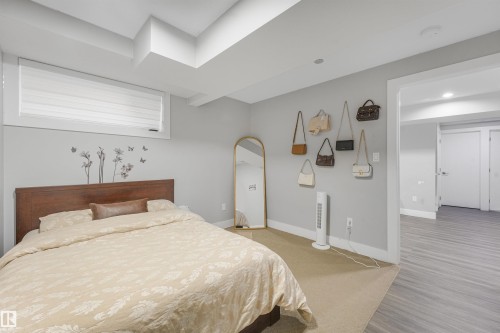 Recessed lighting, wood-finish flooring, and a window with blinds - 3359 13 Avenue Nw, Edmonton, AB 