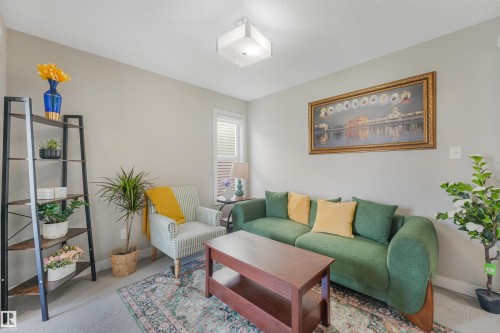 Recessed lighting, wall-to-wall carpeting, and a built-in window with horizontal blinds complement the neutral wall tones - 3359 13 Avenue Nw, Edmonton, AB 