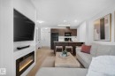 #203 5521 7 Av Sw, Edmonton, AB  - Indoor Photo Showing Living Room With Fireplace 