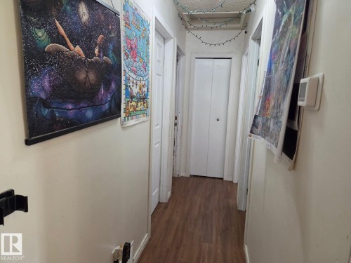 Wood-finish flooring extending through the hallway - 3511 28 Avenue Nw, Edmonton, AB - Indoor