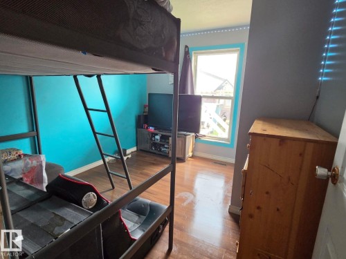 Wood-finish flooring with a window featuring light blue trim - 3511 28 Avenue Nw, Edmonton, AB - Indoor