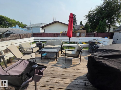 Wood-finish deck with white railings and a wooden privacy fence - 3511 28 Avenue Nw, Edmonton, AB - Outdoor With Deck Patio Veranda