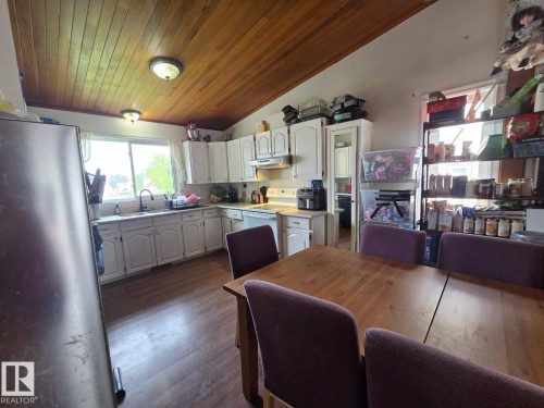 Wood-finish flooring with white cabinetry and a wood-paneled ceiling - 3511 28 Avenue Nw, Edmonton, AB - Indoor