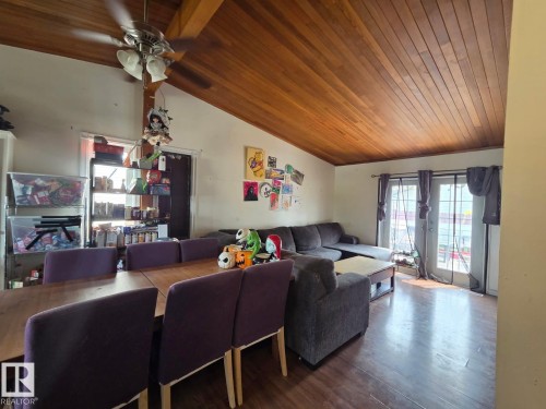 Vaulted wood-finish ceiling, wood-finish flooring, and a ceiling fan with integrated lighting - 3511 28 Avenue Nw, Edmonton, AB - Indoor Photo Showing Living Room