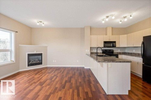 #59 3010 33 Av Nw, Edmonton, AB - Indoor Photo Showing Kitchen With Fireplace