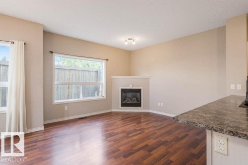 #59 3010 33 Av Nw, Edmonton, AB - Indoor Photo Showing Living Room With Fireplace