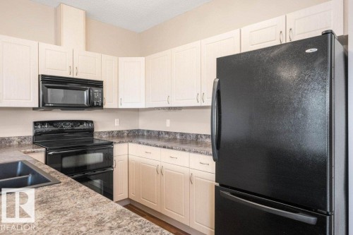 #59 3010 33 Av Nw, Edmonton, AB - Indoor Photo Showing Kitchen With Double Sink