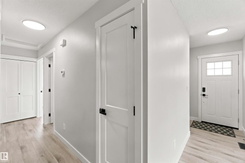Light-toned wood-finish flooring, white walls, white trim, white paneled doors, and ceiling-mounted lighting fixtures - 4129 134A Avenue Nw, Edmonton, AB - Indoor Photo Showing Other Room