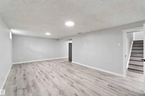 Wood-finish flooring with recessed lighting, light gray walls, and white trim - 4129 134A Avenue Nw, Edmonton, AB - Indoor