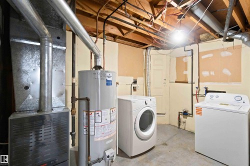 Dedicated utility space with a water heater, furnace, and laundry appliances - 4129 134A Avenue Nw, Edmonton, AB - Indoor Photo Showing Laundry Room