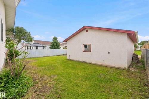 Expansive backyard featuring a detached structure, partial white fence, and mature landscaping - 4129 134A Avenue Nw, Edmonton, AB - Outdoor With Exterior