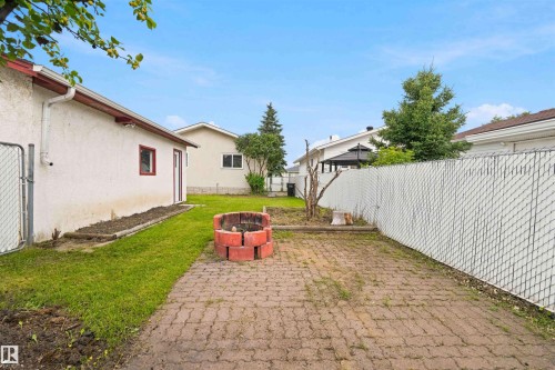 Paved patio area featuring a brick fire pit - 4129 134A Avenue Nw, Edmonton, AB - Outdoor With Exterior