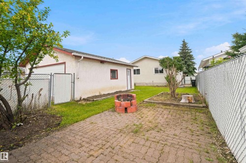 Detached garage with a white stucco exterior and red trim - 4129 134A Avenue Nw, Edmonton, AB - Outdoor