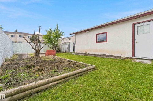 Expansive green space featuring a garden bed with timber edging - 4129 134A Avenue Nw, Edmonton, AB - Outdoor With Exterior