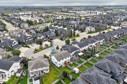 Residential neighborhood featuring a mix of detached and semi-detached homes, established landscaping, and paved streets - 1112 176 Street Sw, Edmonton, AB - Outdoor With View