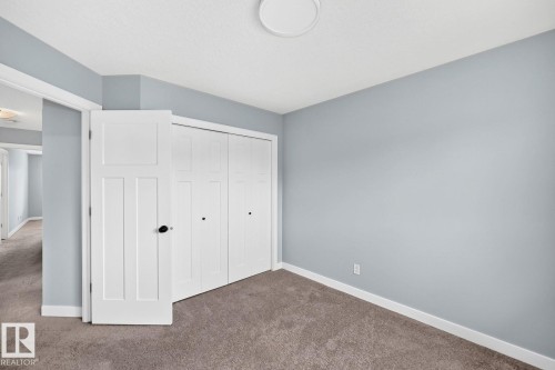 Carpet flooring and a flush-mount ceiling light - 1112 176 Street Sw, Edmonton, AB - Indoor Photo Showing Other Room