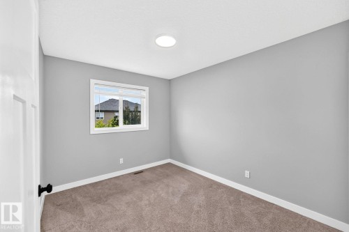 Neutral gray wall paint, white trim, recessed ceiling lighting, single window, and carpet flooring - 1112 176 Street Sw, Edmonton, AB - Indoor Photo Showing Other Room