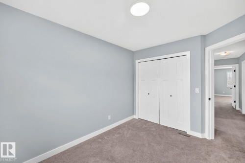 Recessed ceiling lighting, a bi-fold closet, and soft gray carpet flooring - 1112 176 Street Sw, Edmonton, AB - Indoor Photo Showing Other Room
