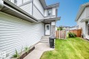 Fiber cement siding exterior with stone accents, a covered entry, and a concrete walkway - 1112 176 Street Sw, Edmonton, AB  - Outdoor 