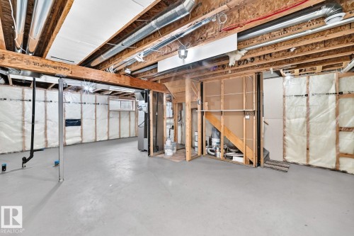 Unfinished basement offering exposed wood framing, concrete flooring, and visible ductwork - 1112 176 Street Sw, Edmonton, AB - Indoor Photo Showing Basement