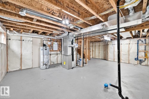 Unfinished lower level featuring exposed wood joists, gray concrete flooring, and insulated perimeter walls - 1112 176 Street Sw, Edmonton, AB - Indoor Photo Showing Basement