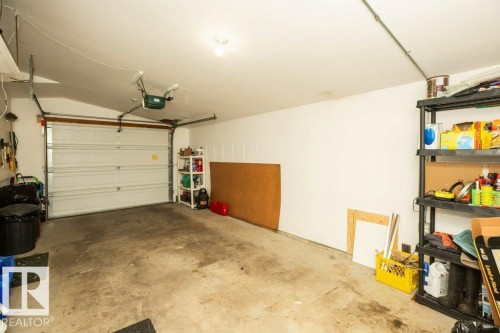 Attached garage featuring a white overhead door and an automatic opener - 10729 108A Avenue, Westlock, AB - Indoor Photo Showing Garage