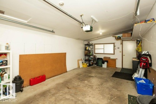 Attached garage with concrete flooring, overhead garage door opener, and natural light from a window - 10729 108A Avenue, Westlock, AB - Indoor Photo Showing Garage