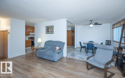 Wood-finish flooring throughout the main living area - 10729 108A Avenue, Westlock, AB - Indoor Photo Showing Living Room