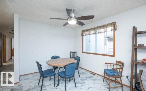 White walls with wood trim, ceiling fan with light, and light-colored flooring - 10729 108A Avenue, Westlock, AB - Indoor Photo Showing Dining Room