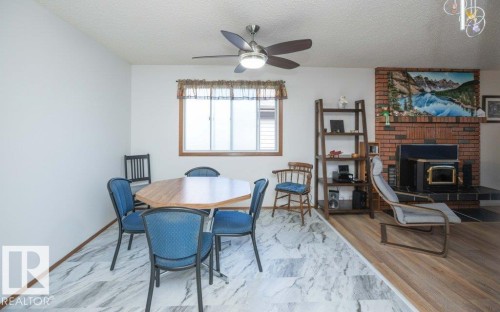 Ceiling fan with integrated lighting - 10729 108A Avenue, Westlock, AB - Indoor Photo Showing Dining Room With Fireplace