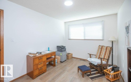 Wood-finish flooring, white walls, and a window with blinds - 10729 108A Avenue, Westlock, AB - Indoor