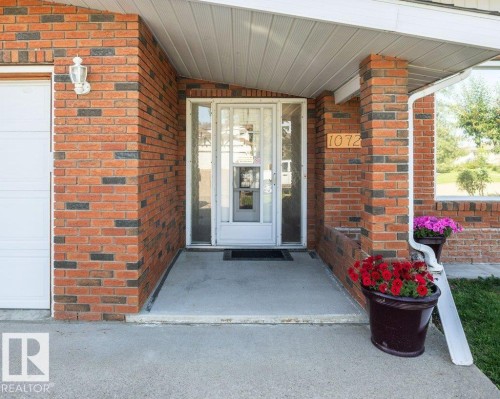 Brick exterior with a covered entry and a concrete porch - 10729 108A Avenue, Westlock, AB - Outdoor With Exterior