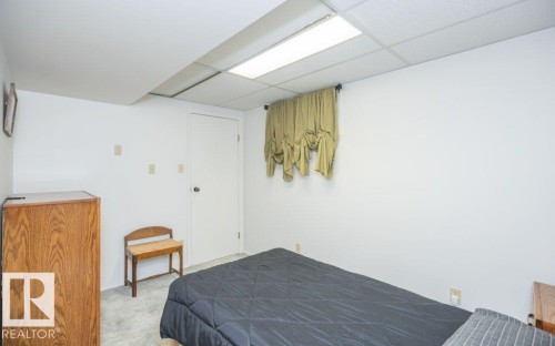 White painted walls with recessed lighting and a drop ceiling - 10729 108A Avenue, Westlock, AB - Indoor Photo Showing Bedroom
