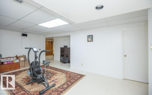 Recessed lighting with a drop ceiling, light-colored flooring, and white walls - 10729 108A Avenue, Westlock, AB - Indoor Photo Showing Gym Room