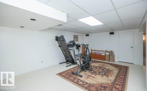 Finished lower level with white walls, recessed ceiling lighting, and a white drop ceiling - 10729 108A Avenue, Westlock, AB - Indoor Photo Showing Gym Room