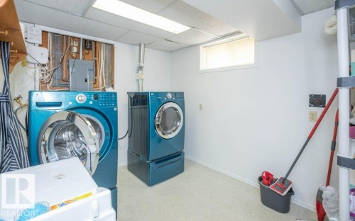 Utility space featuring a drop ceiling, white walls, and a small window - 10729 108A Avenue, Westlock, AB - Indoor Photo Showing Laundry Room