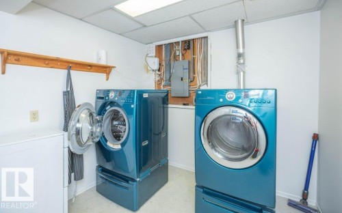White walls with a drop ceiling, featuring a utility area with exposed electrical wiring and a metal vent - 10729 108A Avenue, Westlock, AB - Indoor Photo Showing Laundry Room