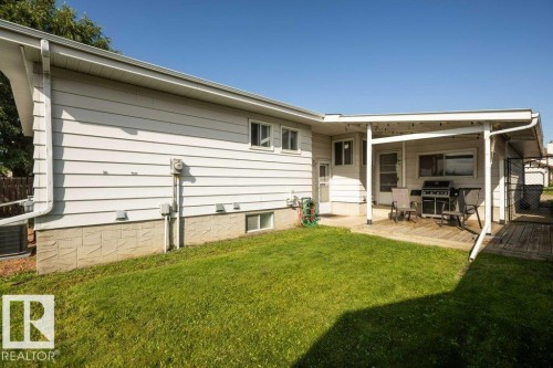 Spacious backyard with lush, manicured lawn and mature tree coverage - 10729 108A Avenue, Westlock, AB - Outdoor