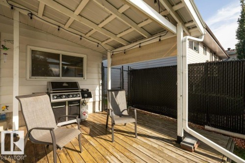 Covered wooden deck featuring a metal roof, string lighting, and privacy screening - 10729 108A Avenue, Westlock, AB - Outdoor With Deck Patio Veranda With Exterior