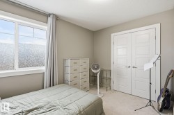 Neutral wall paint, white window trim, dual pane window, white panel doors, and neutral carpet flooring - 