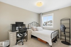 Neutral-toned walls with carpet flooring, a white-framed window, and a flush-mount ceiling light fixture - 