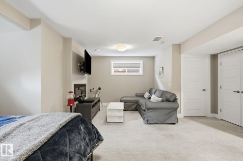 Carpeted flooring, recessed lighting, and two panel doors with contemporary hardware - 944 Morris Way, Leduc, AB - Indoor Photo Showing Bedroom
