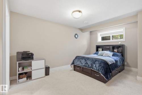 Recessed window with white trim, soft neutral wall color, and light-toned carpeting - 944 Morris Way, Leduc, AB - Indoor Photo Showing Bedroom