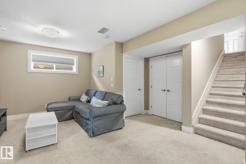 Carpeted flooring throughout, neutral paint colors, white trim, recessed window, and white paneled doors - 944 Morris Way, Leduc, AB - Indoor