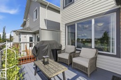 Exterior deck featuring a gray finish, white railing, and sliding glass door - 