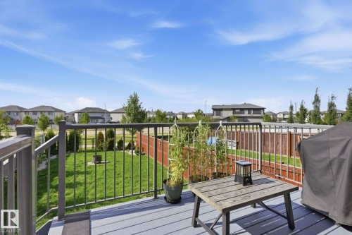Expansive deck with gray composite decking, featuring a black metal railing - 944 Morris Way, Leduc, AB - Outdoor With Deck Patio Veranda