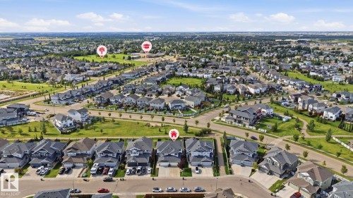 Aerial perspective of a developed residential community with ample green spaces and established street networks - 944 Morris Way, Leduc, AB - Outdoor With View