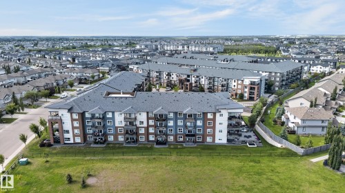 Multi-story residential buildings with balconies and varied exterior finishes - #131 5504 Schonsee Dr Nw, Edmonton, AB - Outdoor With View